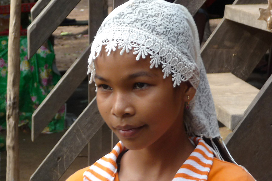 95 - Young girl with enigmatic look in Vietnam, wearing laced head band.