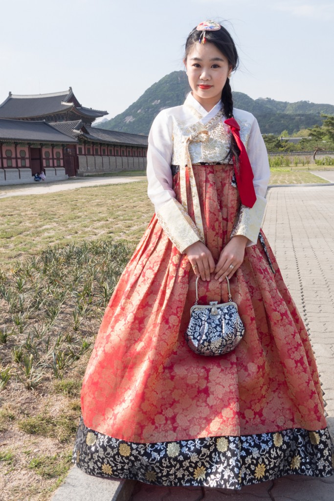 Young Korean lady in national dress outside wall of castle in Seoul, April 2017 #432