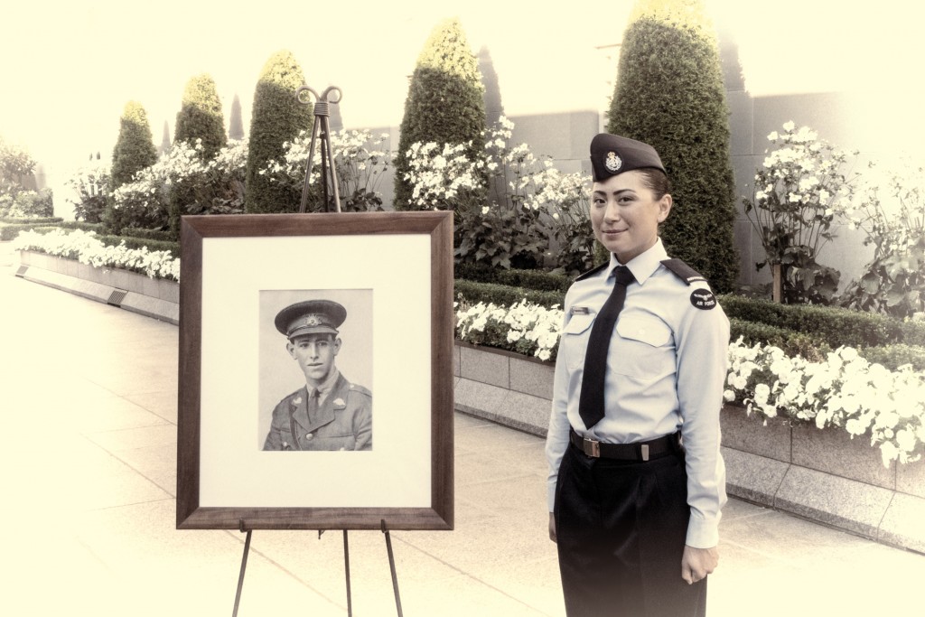 #495.  Airforce lady standing beside photo of deceased soldier at Canberra War Memorial. Marcy 2018.